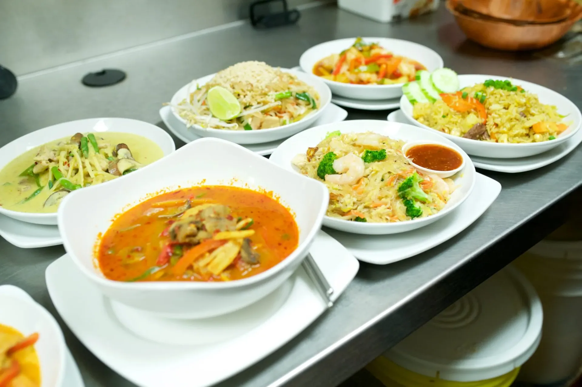 Authentic Thai dishes — green curry, pad thai and red curry with fresh basil and chilies